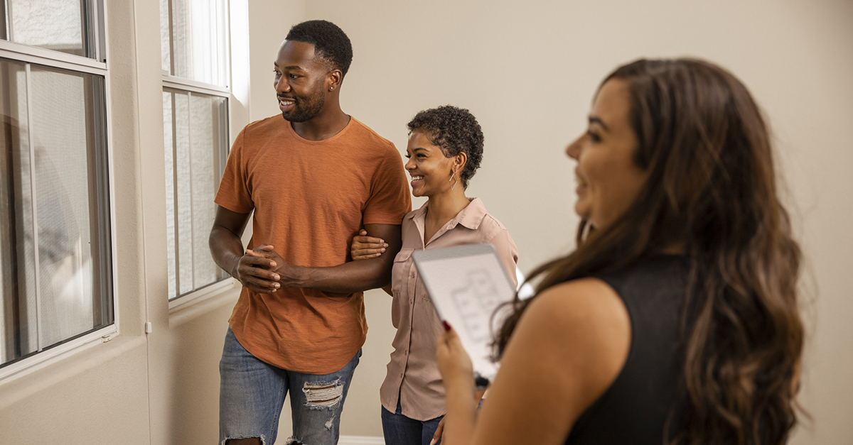 A young couple shopping for a house with their agent