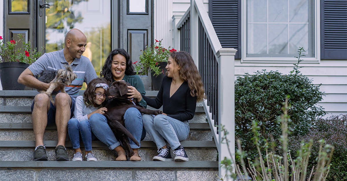 A family on the front porch of their home.